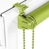 A close-up view of a green roller blind mechanism attached to a white window frame. Produktbild-Vorschau