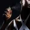 A person spraying perfume. Produktbild-Vorschau