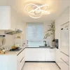 A modern kitchen with white cabinets and a sleek ceiling light. Produktbild-Vorschau