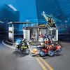 A Playmobil police station playset with vehicles and figures, set against a city backdrop. Náhľad obrázku produktu