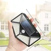 A hand holding a solar-powered outdoor light with a house in the background. Voir les images du produit