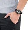 A person's wrist wearing a watch, with their hand in their pocket. Anteprima dell’immagine prodotto
