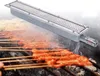 A metal grill burner is shown above a grill with meat skewers cooking. Náhled obrázku produktu