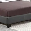 A close-up view of a bed frame with a fitted sheet. Náhled obrázku produktu