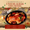 A roasted duck with apples and herbs in a cast iron pot, surrounded by ingredients and kitchen tools. Voir les images du produit