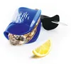 An oyster knife with a blue silicone holder, an oyster, and a lemon slice on a white background. Produktbild-Vorschau