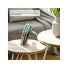 A handheld vacuum cleaner on a coffee table in a living room setting. Anteprima dell’immagine prodotto