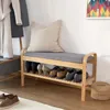 A bench with a shoe rack underneath and a pillow on top, next to a coat rack. Produktbild-Vorschau