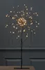 A black LED starburst light stand on a table against a dark background. Produktbild-Vorschau