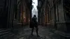 A lone knight in dark armor stands in a gothic-style alleyway, facing away from the camera. The alley is flanked by ornate stone architecture with arched doorways and columns. In the distance, a large cathedral or castle structure is visible through the fo Produktbild-Vorschau