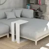 A white C-shaped side table is placed on a sectional sofa next to a bookshelf. Anteprima dell’immagine prodotto