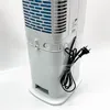 The back of a white portable air cooler is shown, with the power cord wrapped around the back. The blue cooling element is visible through the grille. Produktbild-Vorschau