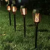 Four solar-powered garden torches with a flame effect are planted in a grassy lawn at dusk. Náhľad obrázku produktu