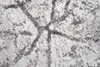 A close-up view of a textured rug with a modern abstract pattern in beige and gray tones. Náhled obrázku produktu