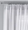 A close-up view of white sheer curtains hanging from a curtain rod. Produktbild-Vorschau