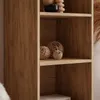 A close-up view of a wooden shelf unit with decorative items. Produktbild-Vorschau