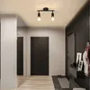 A modern hallway with a black door, a white pillar, and a black slatted wall. Náhľad obrázku produktu