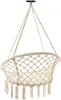 A beige macrame hanging chair with fringes, suspended from a black hook against a white background. Podgląd zdjęcia produktu