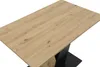 A close-up view of a table with a wood-look top and a black base. Produktbild-Vorschau