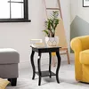 A black wooden side table with a plant and books on it, placed next to a grey ottoman and a yellow armchair in a living room. Podgląd zdjęcia produktu