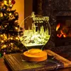 A Harry Potter-themed LED lamp sits on a book in front of a Christmas tree and a fireplace. Produktbild-Vorschau