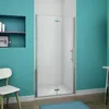 A modern bathroom with a turquoise wall and a glass shower enclosure. Produktbild-Vorschau