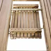 A close-up view of the wooden slats and metal hardware of an extendable table. Produktbild-Vorschau