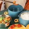 A person is using chopsticks to pick up a shrimp from a lunchbox. Produktbild-Vorschau