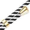 A close-up view of a black and white striped cord with gold-colored metal accents. Produktbild-Vorschau