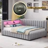 A modern, L-shaped sofa bed with integrated LED lighting and USB charging ports, set up in a bedroom or living room. Náhled obrázku produktu