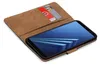 A book-style phone case with two credit cards inserted, shown with a smartphone inside. Produktbild-Vorschau