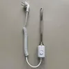 A white electric heating element with a coiled cord and a white plug is placed on a light gray background. Anteprima dell’immagine prodotto