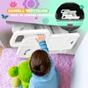 A child's hand reaches for a white baby step stool. The stool is shown in use, and a separate inset shows it folded in a car trunk. Produktbild-Vorschau