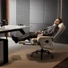 A man in a suit is relaxing in an ergonomic office chair with his feet up, in a modern office setting. Náhled obrázku produktu