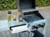 A barbecue grill with various condiments and a paper towel holder attached to the side. Anteprima dell’immagine prodotto