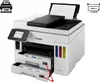 A Canon MAXIFY GX 7050 Multifunction Printer is shown from a diagonal front-left perspective, with its paper trays extended. Produktbild-Vorschau