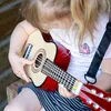 A child playing a toy guitar. Náhled obrázku produktu