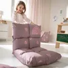 A young girl is playing with a floor chair in a child's room. Anteprima dell’immagine prodotto