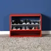 A red shoe cabinet filled with various shoes, placed against a blue wall and on a gray carpet. Voir les images du produit