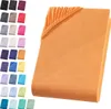 A folded orange fitted sheet is shown on a white background, with a swatch of smaller colored fitted sheets displayed to the left. Produktbild-Vorschau