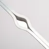 A close-up abstract view of a silver metal object with a curved, flowing shape, possibly part of a table or furniture. Anteprima dell’immagine prodotto