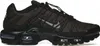 A side view of a black Nike Air Max Plus TN Utility sneaker against a white background. Voir les images du produit