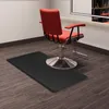 A salon chair and a black floor mat in a salon setting. Náhled obrázku produktu