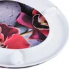 A close-up view of a toilet seat with a floral and stone design. Produktbild-Vorschau