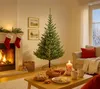 A decorated living room with a fireplace, Christmas tree, and sofa, set for a festive occasion. Produktbild-Vorschau
