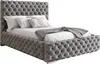 A tufted upholstered bed with pillows and a blanket. Produktbild-Vorschau