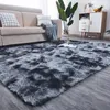 A shaggy plush rug in a living room setting, with a sofa and furniture in the background. Podgląd zdjęcia produktu