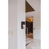 An interior hallway with a modern wall light fixture and stairs. Anteprima dell’immagine prodotto