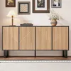 A modern sideboard with a slatted wood-look front and black metal legs, displayed in a room setting with framed pictures on the wall and a rug on the floor. Anteprima dell’immagine prodotto