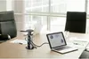 A conference table with a power strip, laptops, and chairs. Produktbild-Vorschau